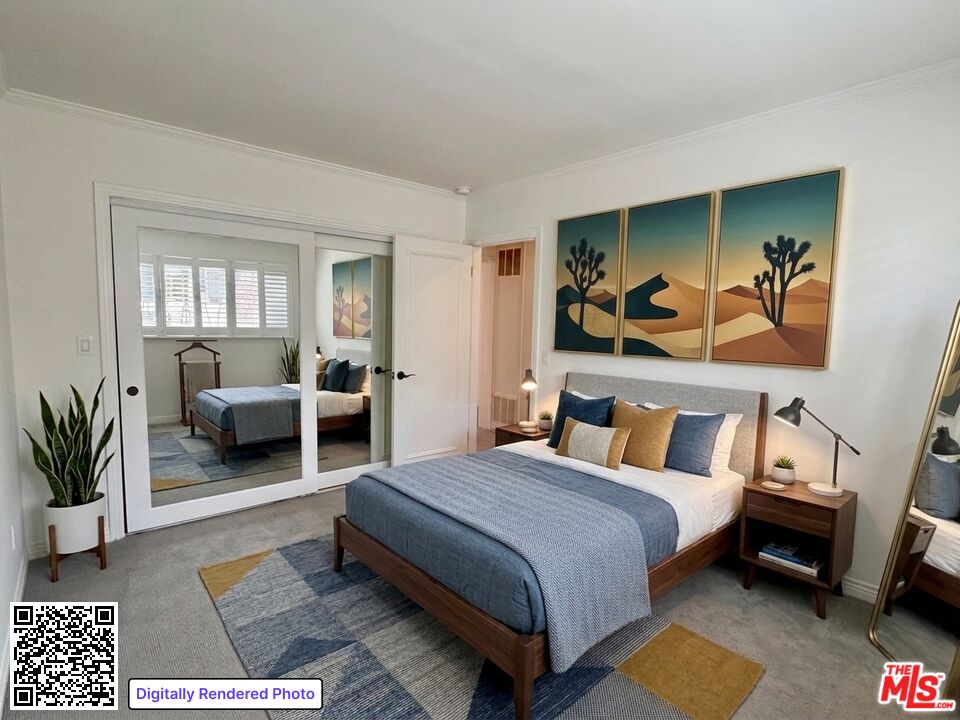 Bedroom with a blue-dressed wood bed, desert artwork, and mirrored doors opening onto a second sleeping area.