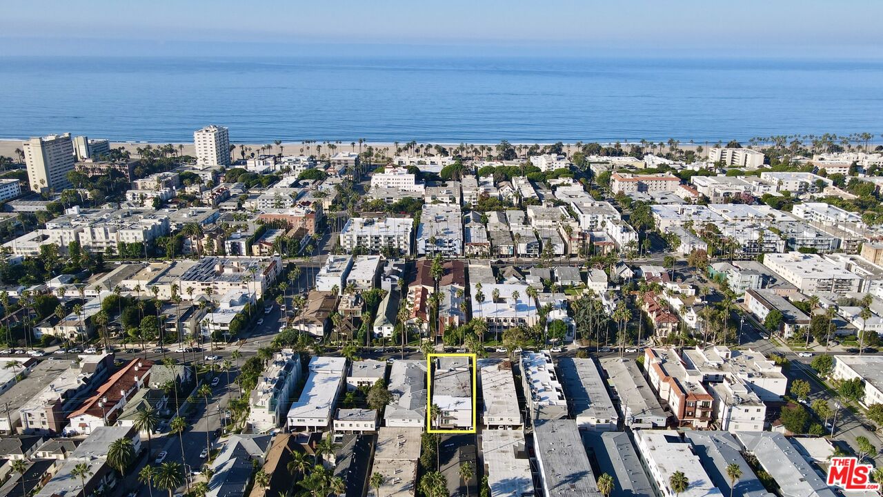 Aerial view of a Santa Monica neighborhood, with the ocean beyond and one building outlined in yellow.