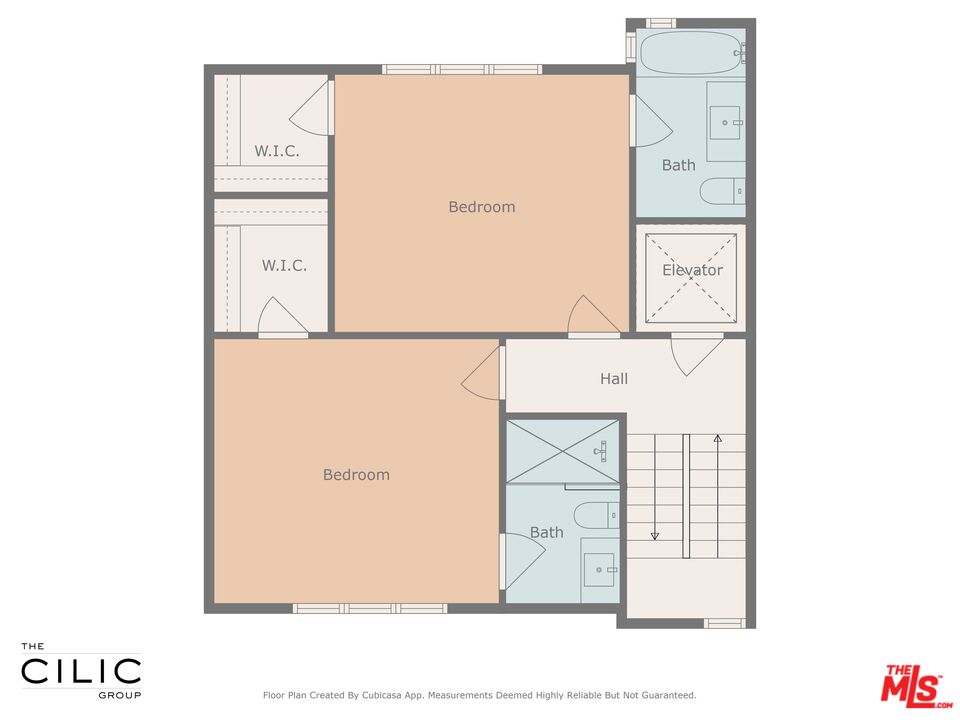 Floor plan with two bedrooms, two bathrooms, two walk-in closets, stairs, and an elevator.