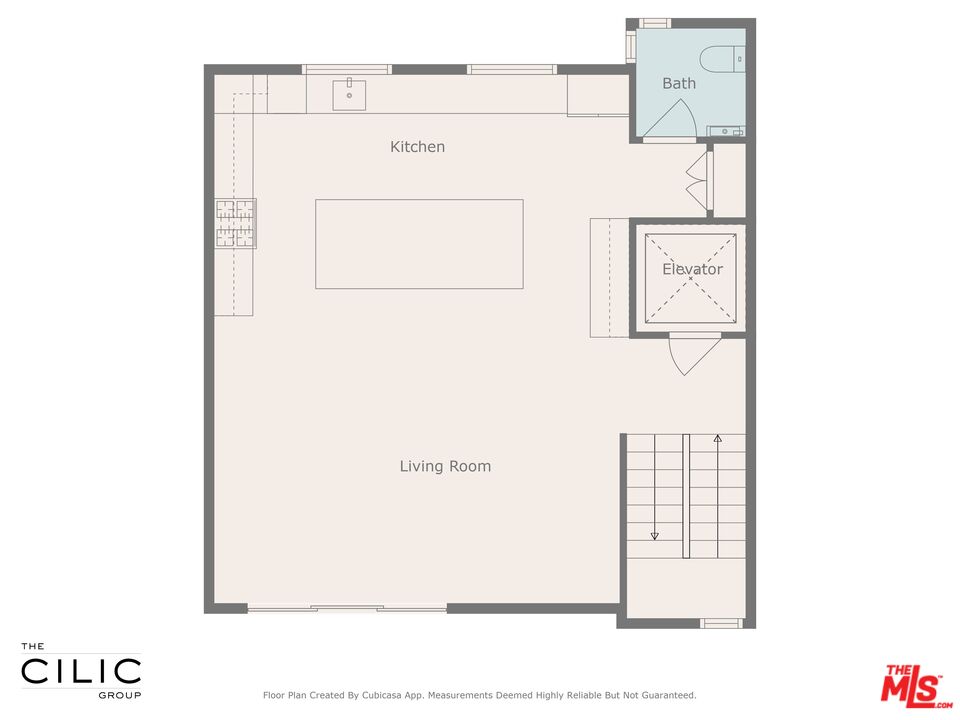Floor plan of an open kitchen and living room with a bathroom, elevator, and stairs.