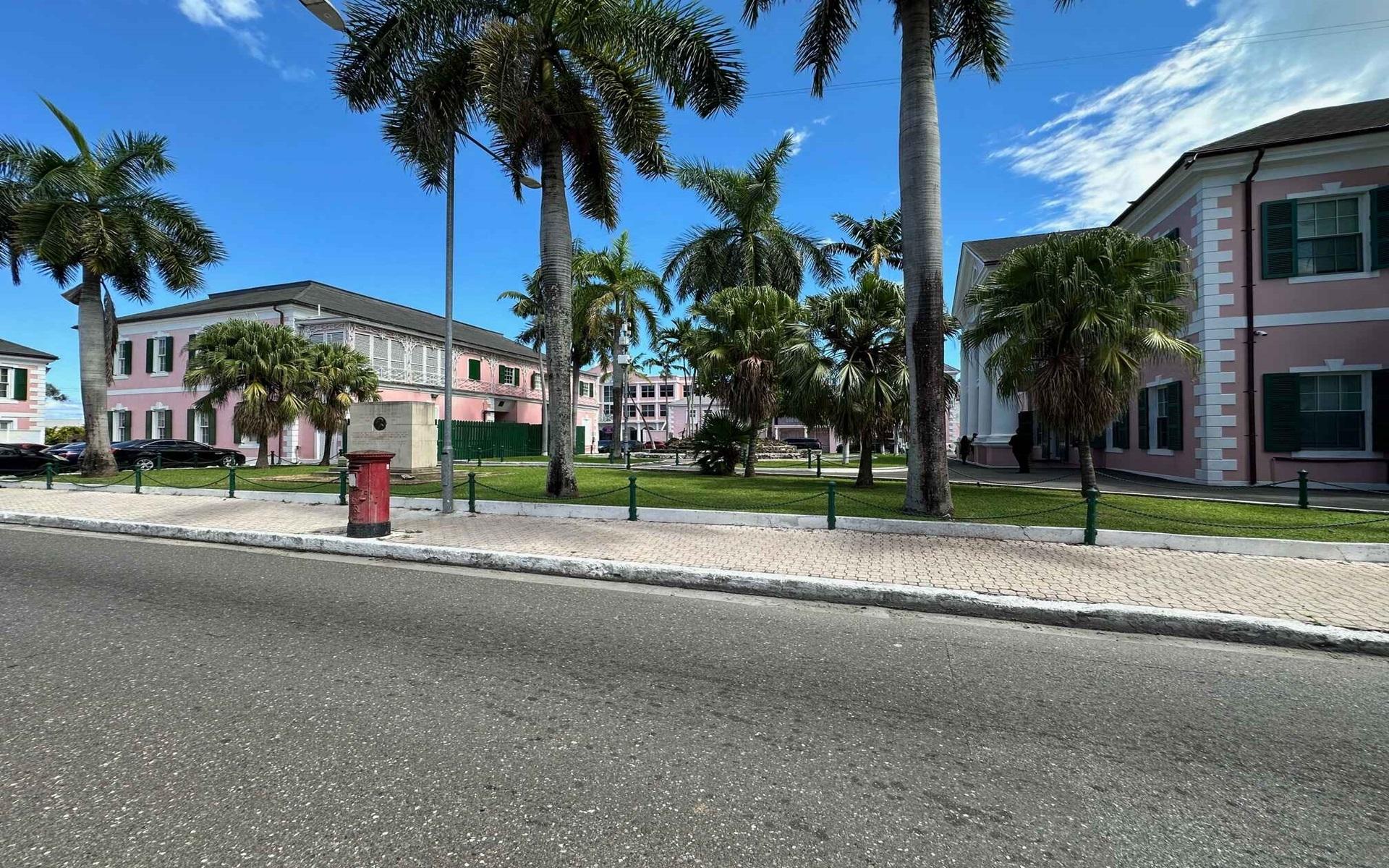Bayparl Building’s pink façades and palm-lined courtyard along Parliament Street.