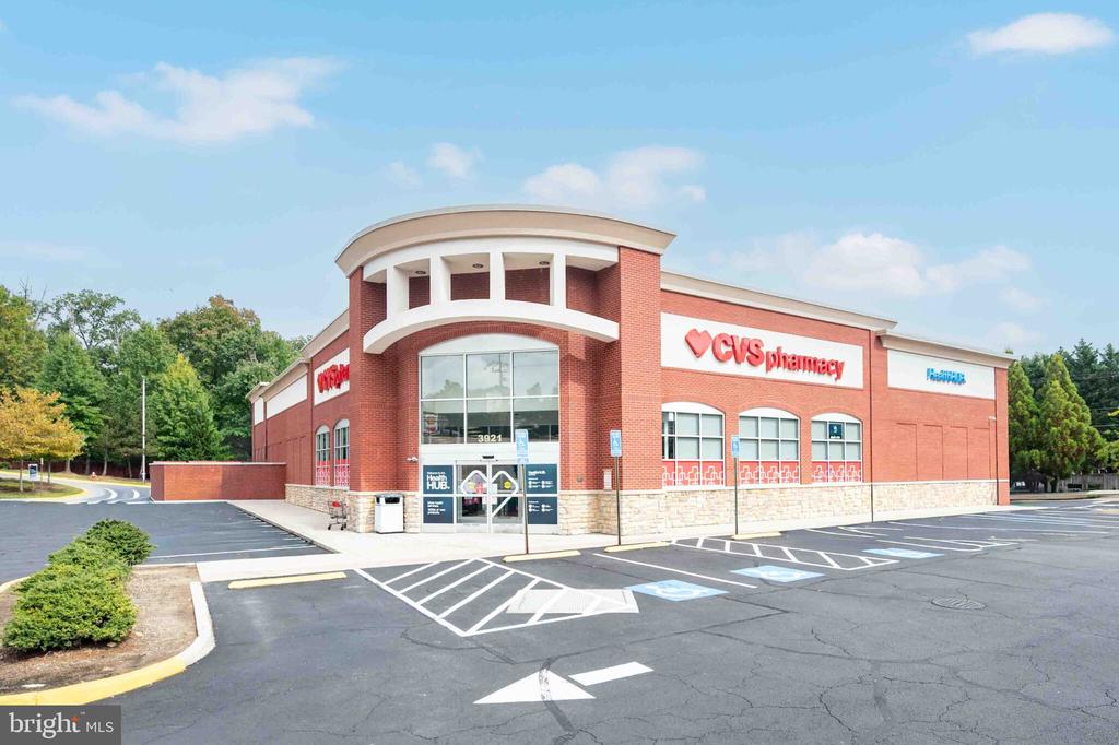 CVS Pharmacy exterior with a curved brick entrance and accessible parking spaces in front.