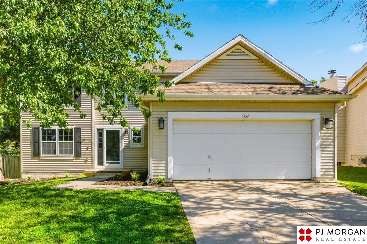 House at 15132 Borman Street with a wide double garage and a large leafy tree.