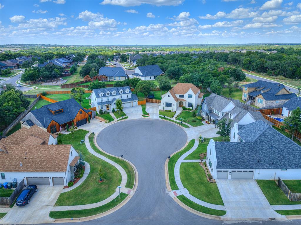 Aerial view of a leafy residential cul-de-sac surrounded by detached homes.