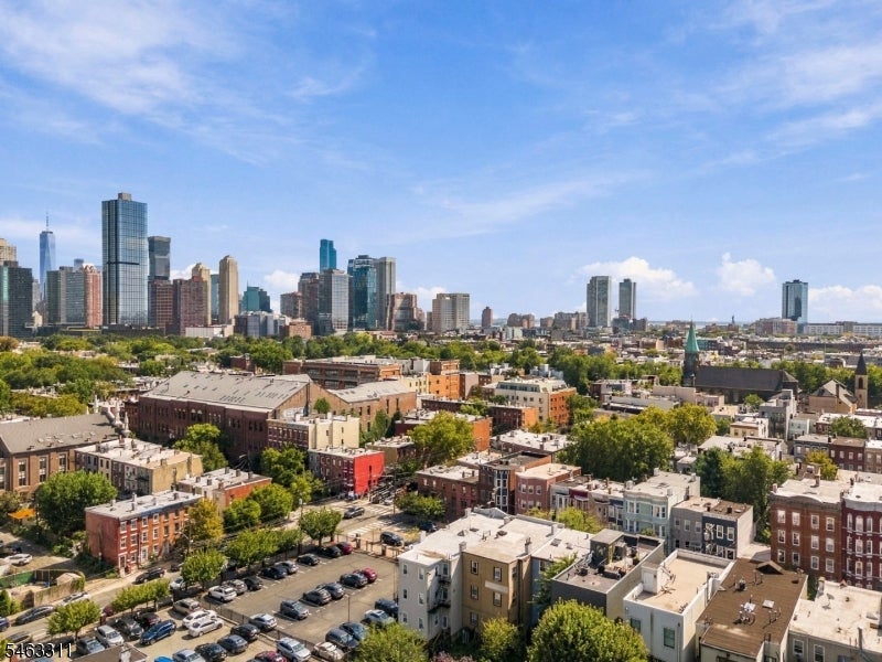 Jersey City rooftops with the Manhattan skyline in the distance.