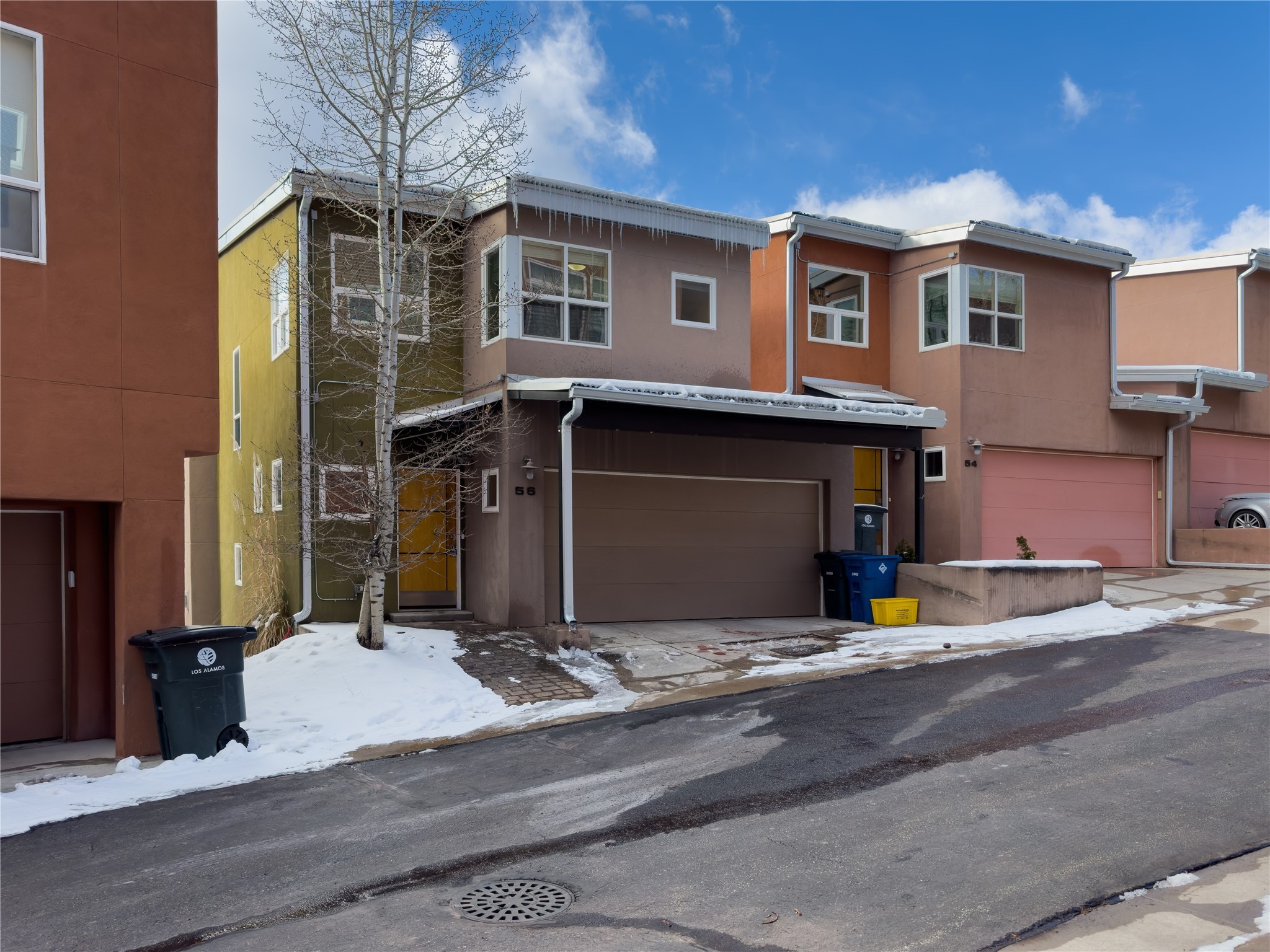 Townhouse at 56 Canyon View with a double garage and snow-covered sidewalk.
