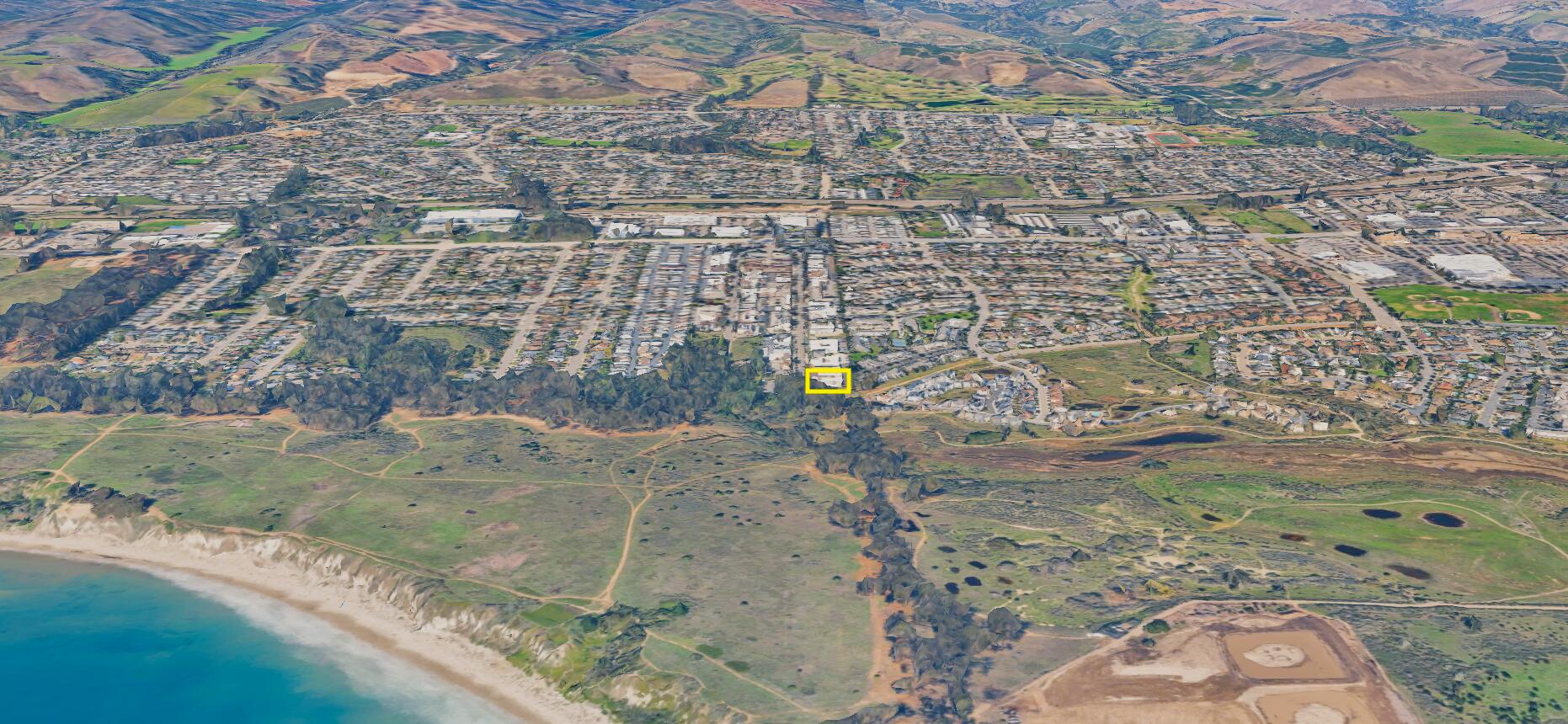 Aerial view of the marked property beside coastal open space, cliffs, and ocean.