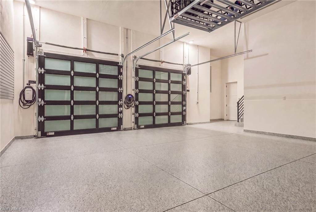 Two-car garage with glass-paneled doors and polished speckled flooring.