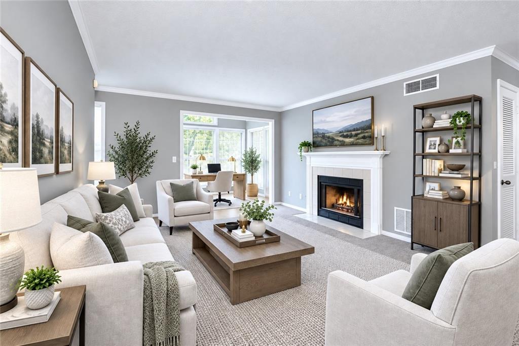 Staged living room with a lit fireplace, light seating, and a bright adjoining room.