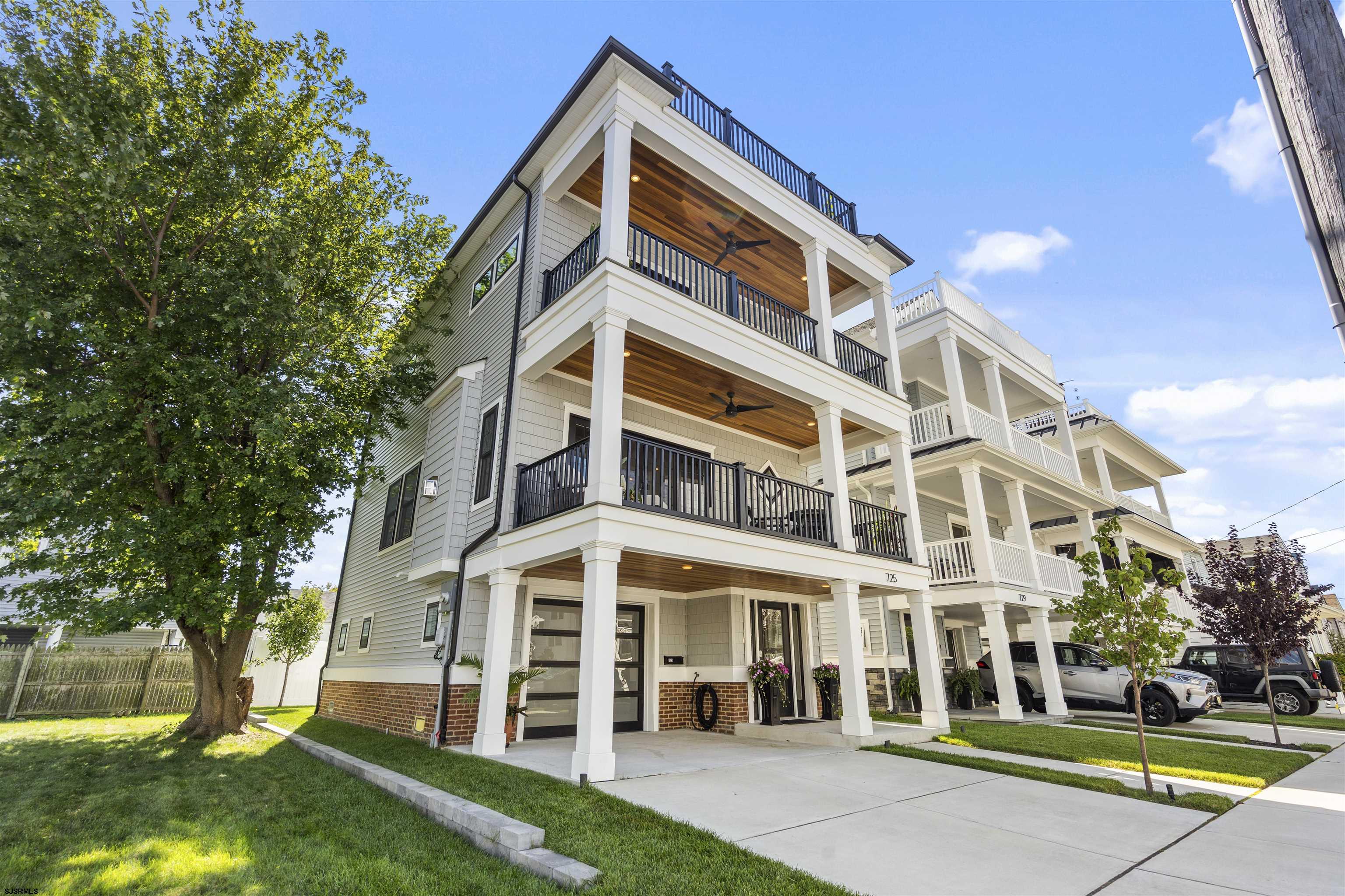 725 Simpson’s multistory exterior with stacked covered balconies, white columns, and wood-paneled ceilings.