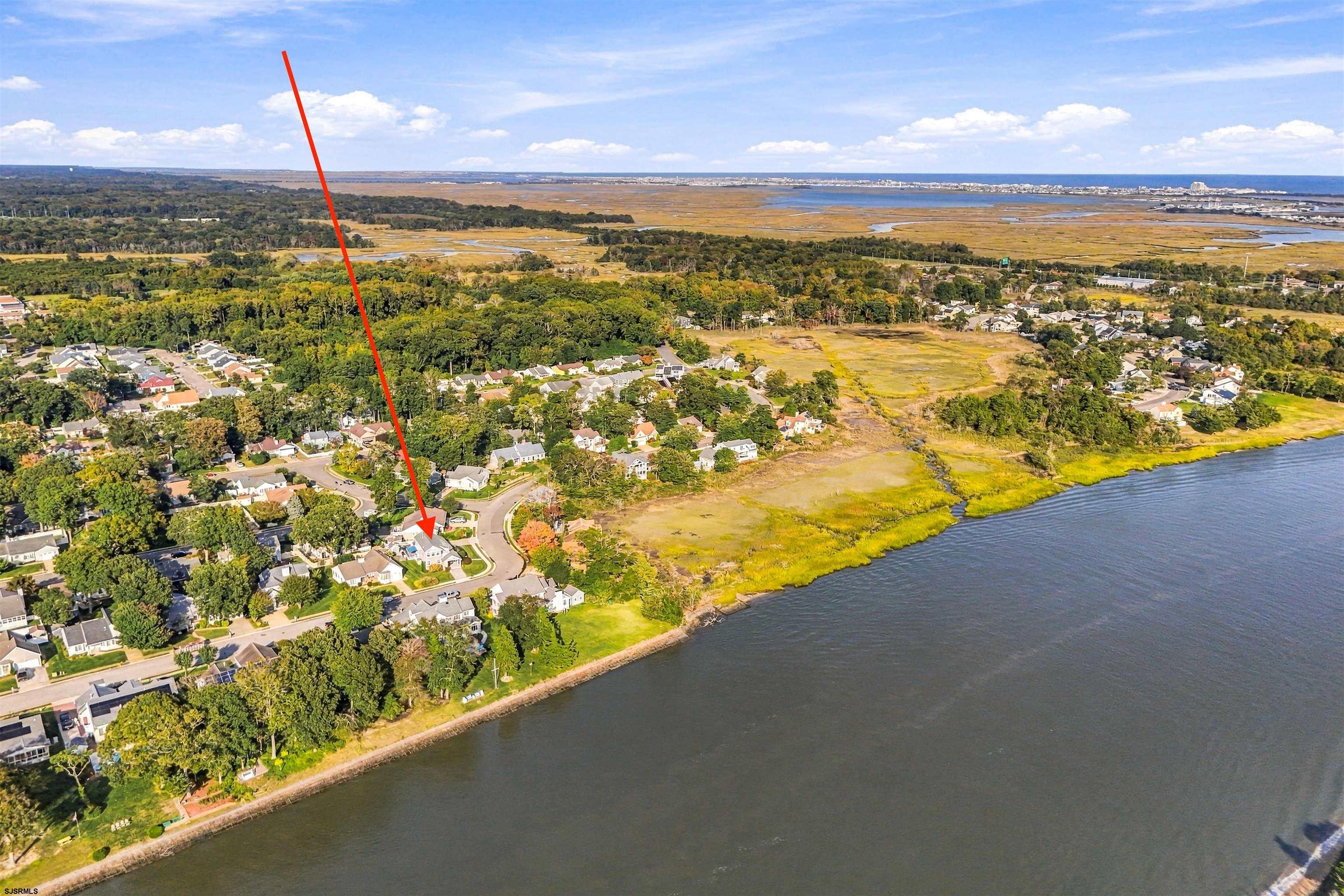 Aerial view of the waterfront home at 415 Portsmouth Road, marked by a red arrow.