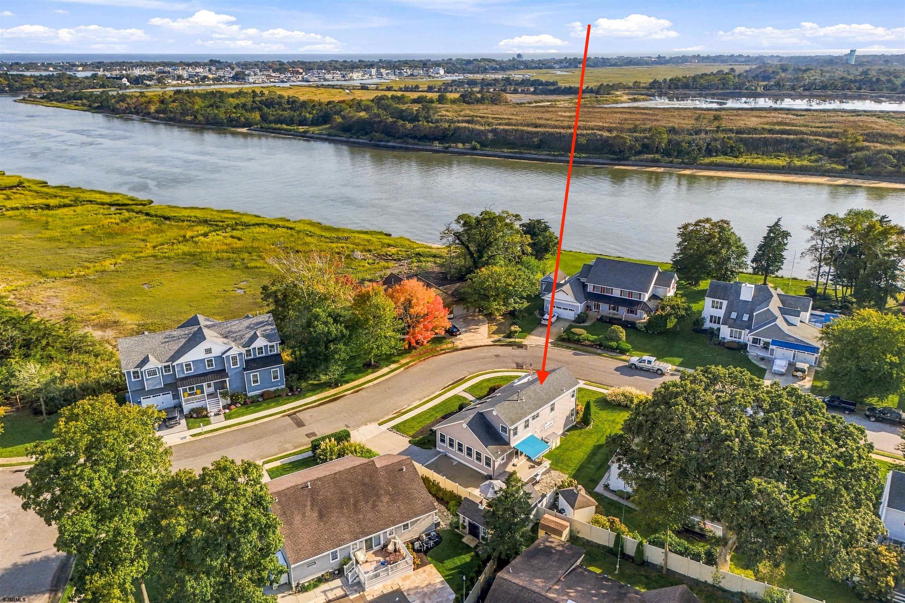 Aerial view of 415 Portsmouth Road beside a river and marsh, marked with a red arrow.