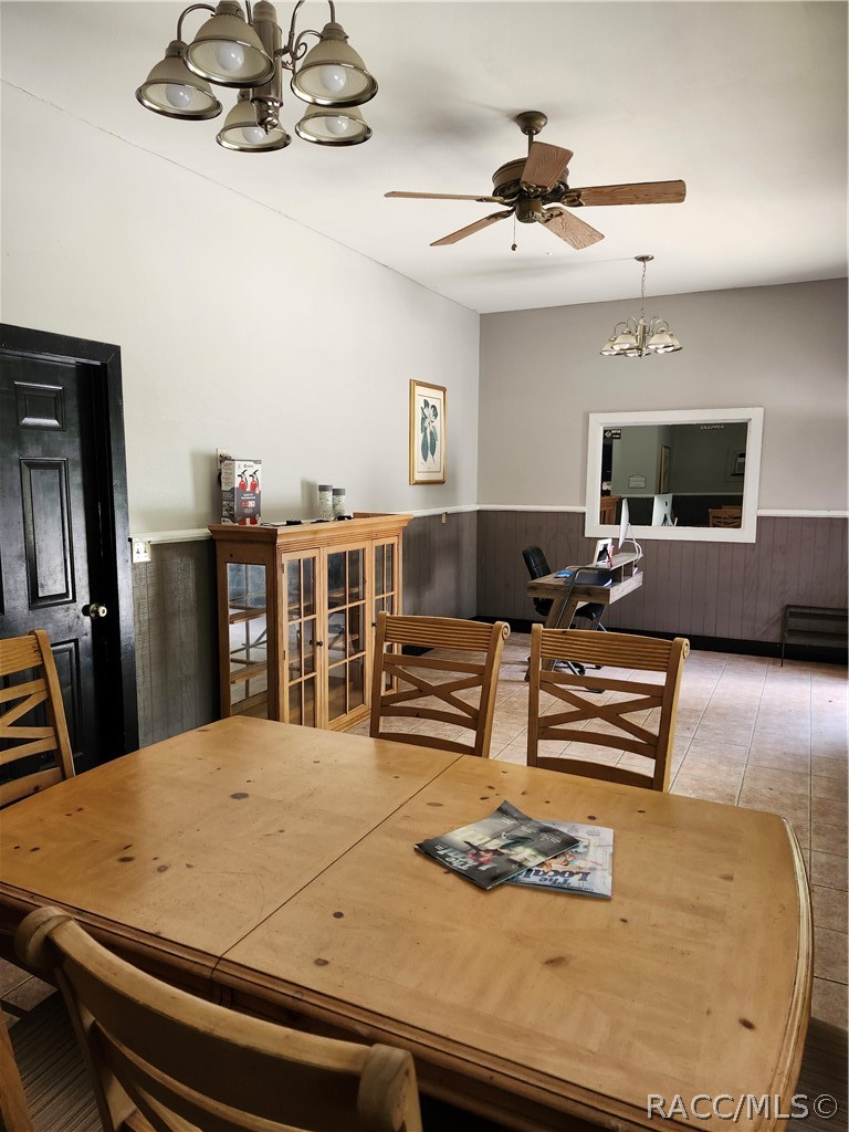 Meeting room with a large wooden table, chairs, and a glass-front cabinet