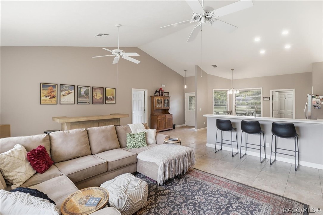 Living room with a sectional sofa and open kitchen with breakfast bar.