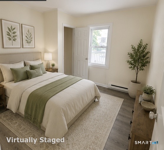 Virtually staged bedroom with a white bed, sage-green bedding accents, botanical prints, and a large potted plant.