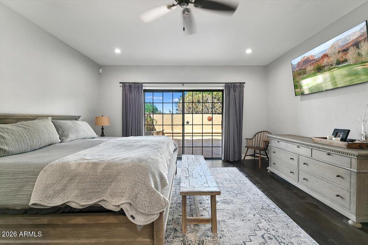 Bedroom with a large bed and sliding glass doors opening to a patio.