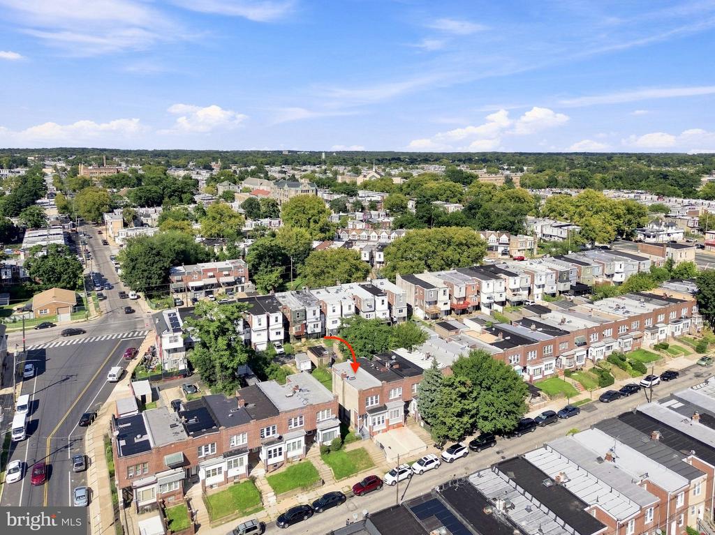 Aerial view of a Philadelphia rowhouse neighborhood, with a red arrow marking the property.