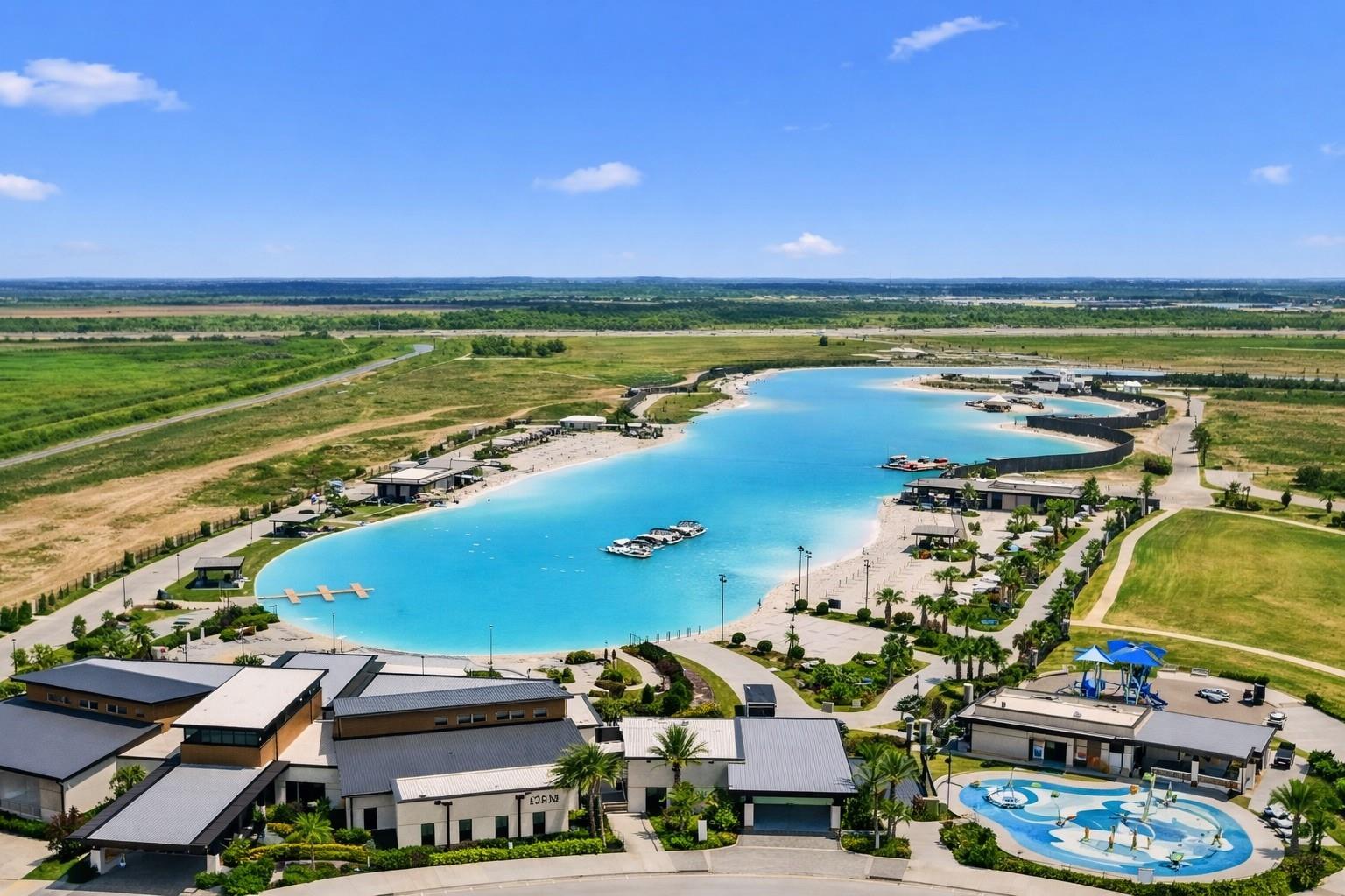 Aerial view of a turquoise recreational lagoon with docks and a separate splash pool.