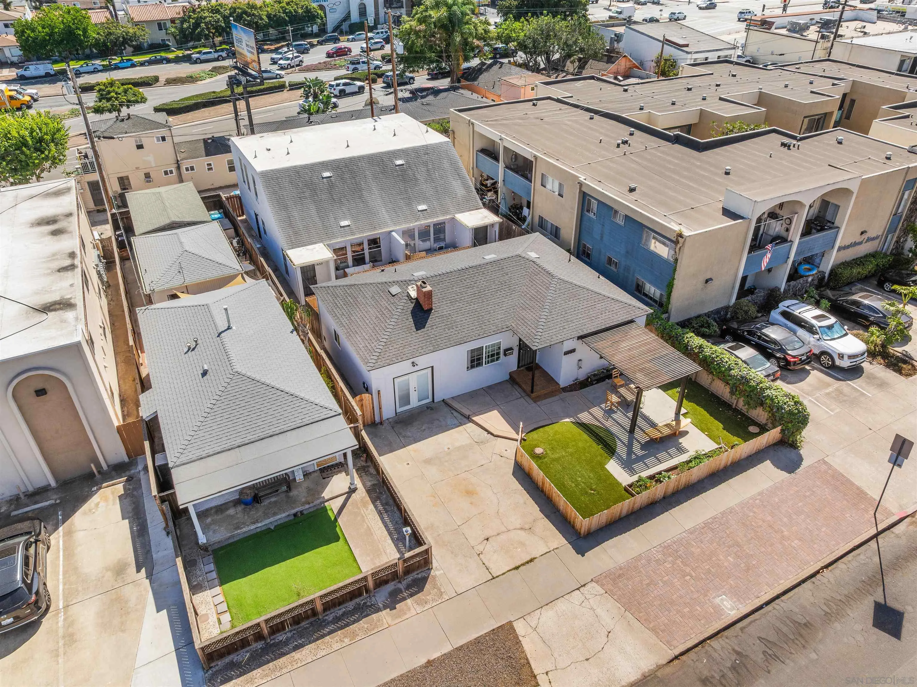 Aerial view of 1951–55 Hornblend Street properties, with fenced yards and patios.