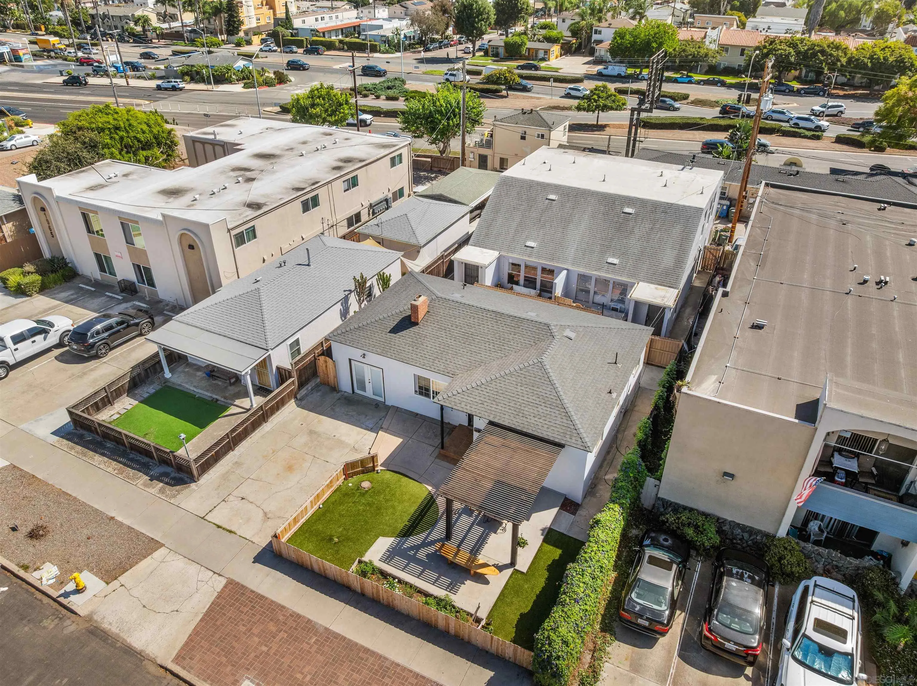 Aerial view of 1951-55 Hornblend St. properties with fenced yards and a pergola.
