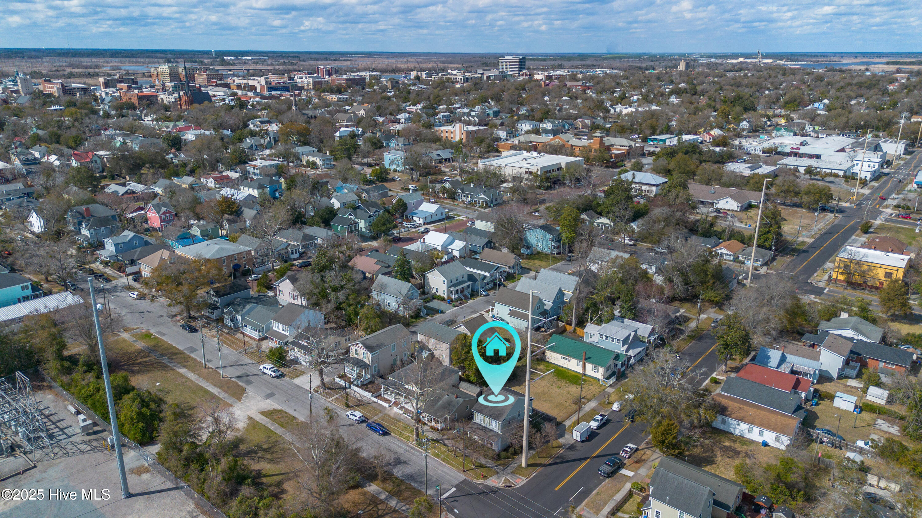 Aerial view of a residential neighborhood with a turquoise marker identifying 921 Orange Street.