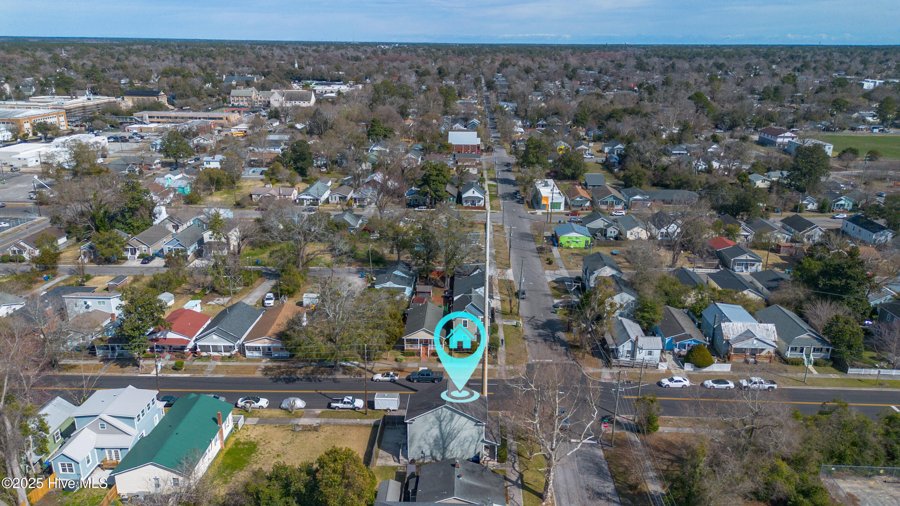 Aerial neighborhood view with a turquoise map pin marking 921 Orange Street.