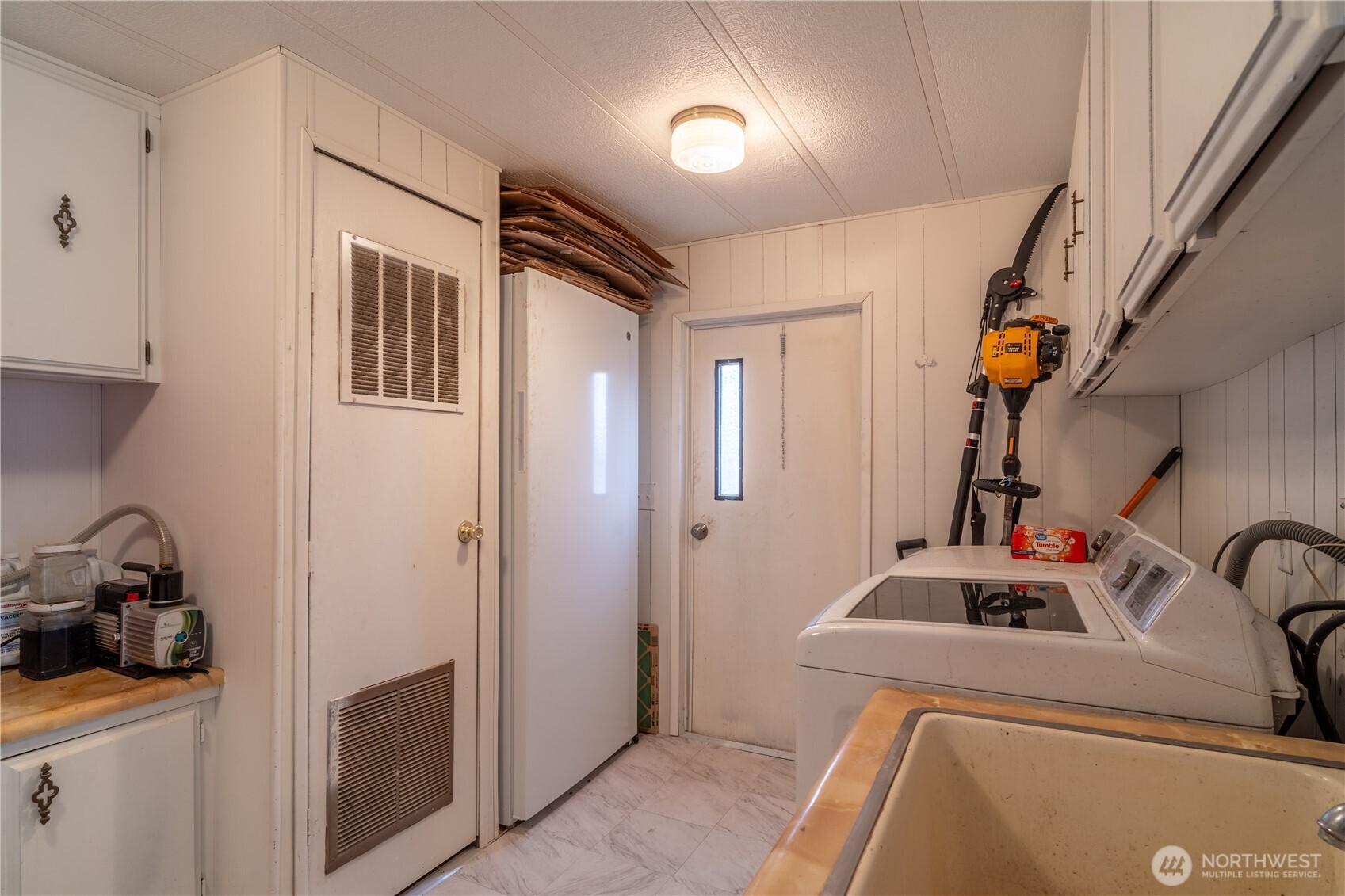 Laundry room with a washer and dryer, utility sink, and vented utility closet.