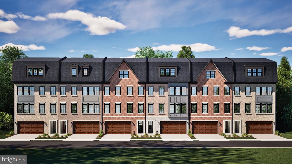 Row of attached townhouses with brick facades, dormer windows, and individual garages.