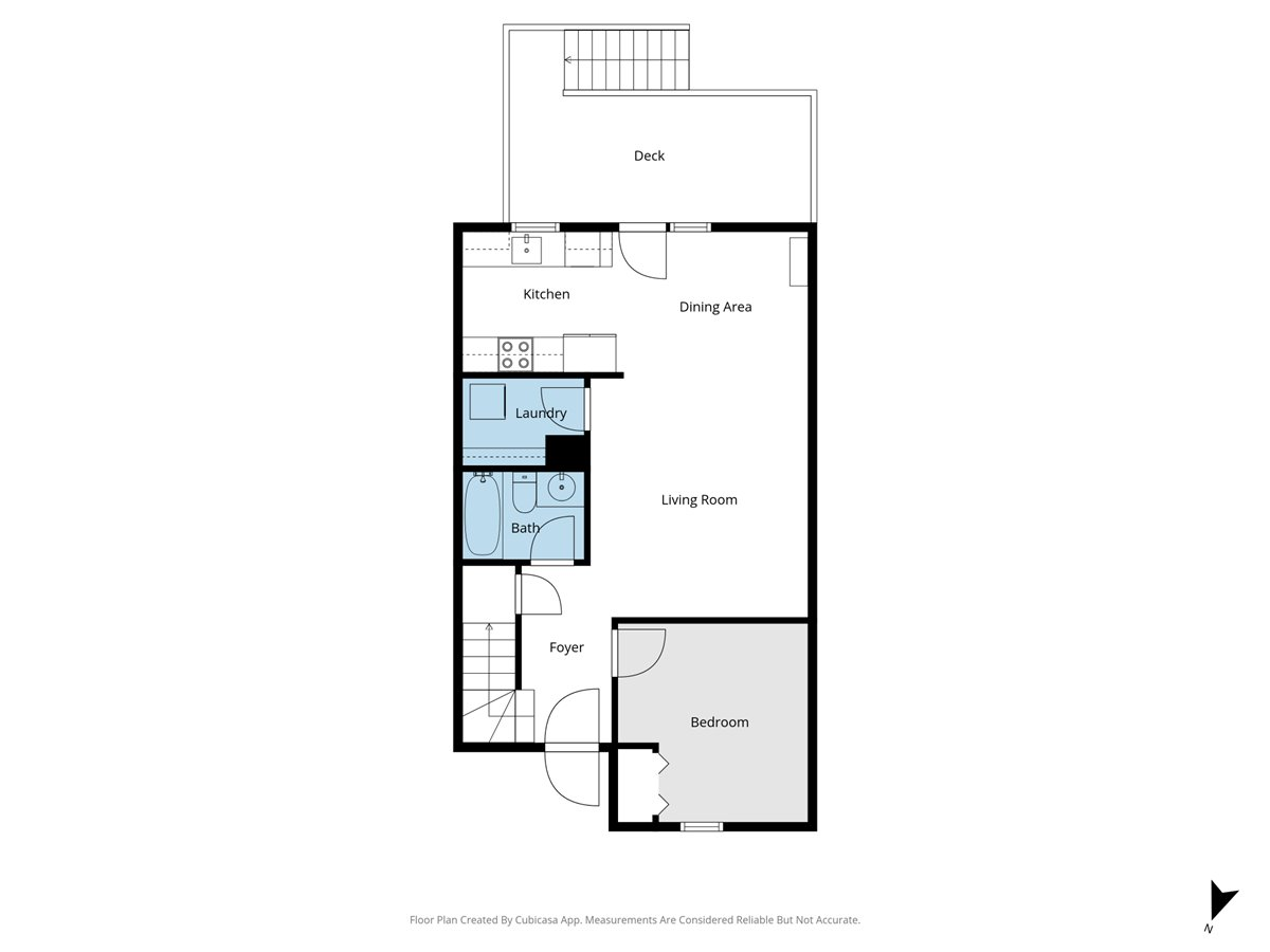Floor plan of a one-bedroom home with an open living and dining area and a deck.