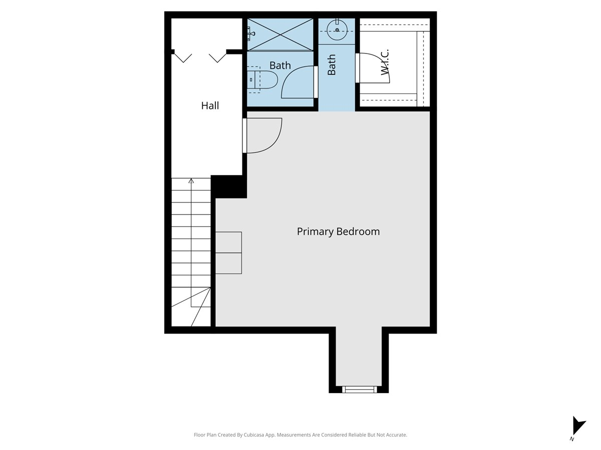 Upper-level floor plan with a large primary bedroom, walk-in closet, two baths, hall, and stairs.
