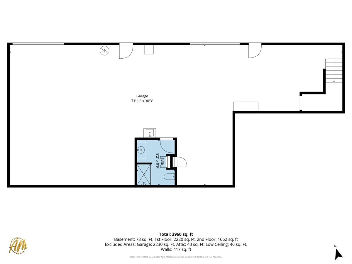 Floor plan showing a large garage, bathroom, stairs, and square-footage measurements.