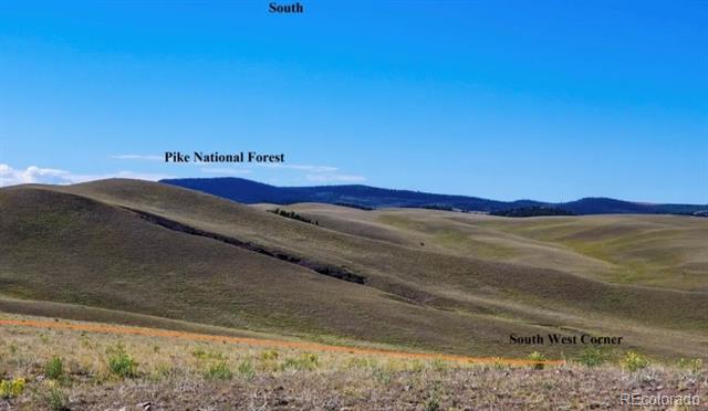Open rolling land with Pike National Forest visible on the distant horizon.