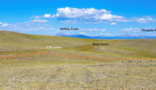Open grassy land with distant mountain views; annotations mark the northwest corner and road access.