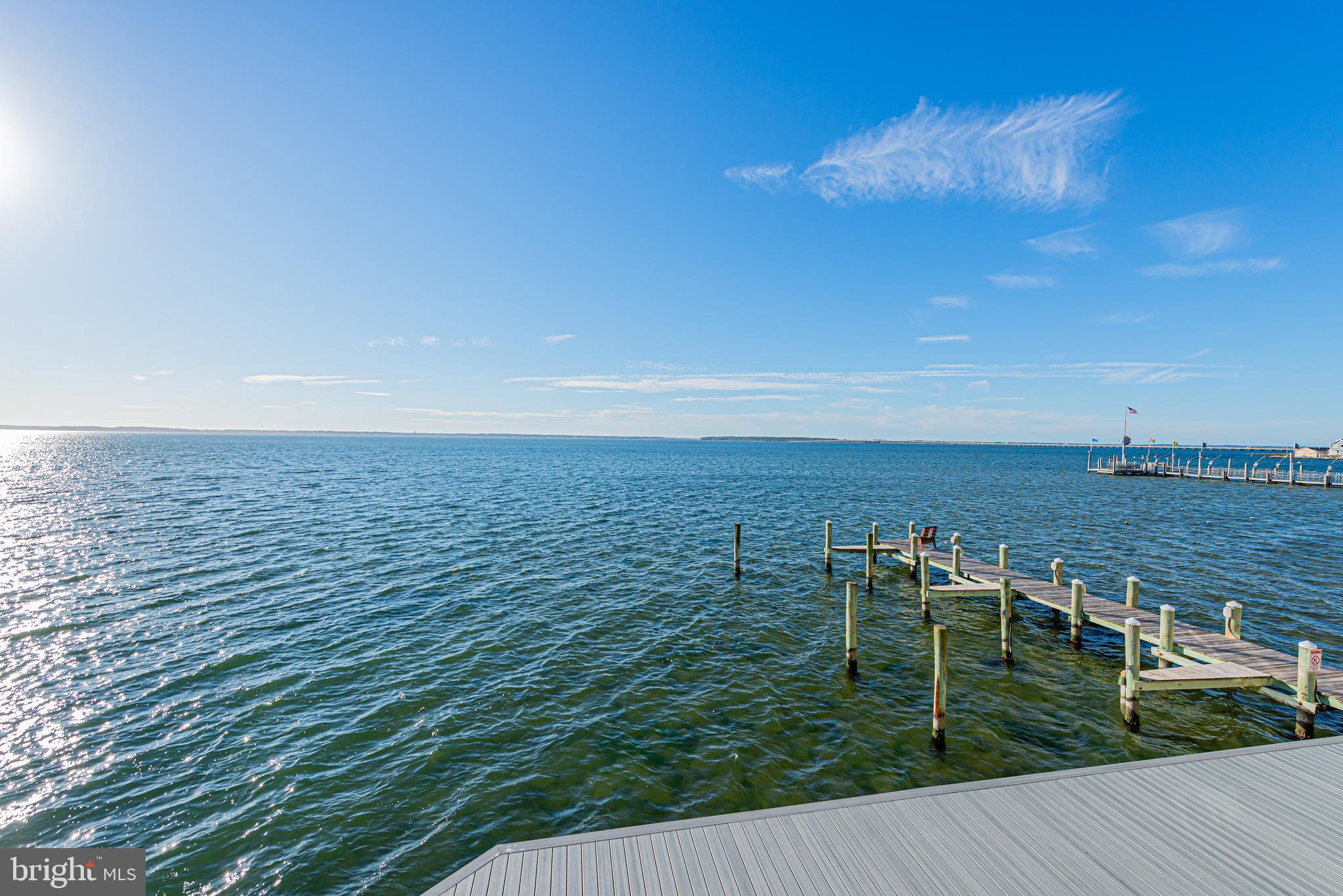 Open-water view with wooden docks and pilings extending into the bay.