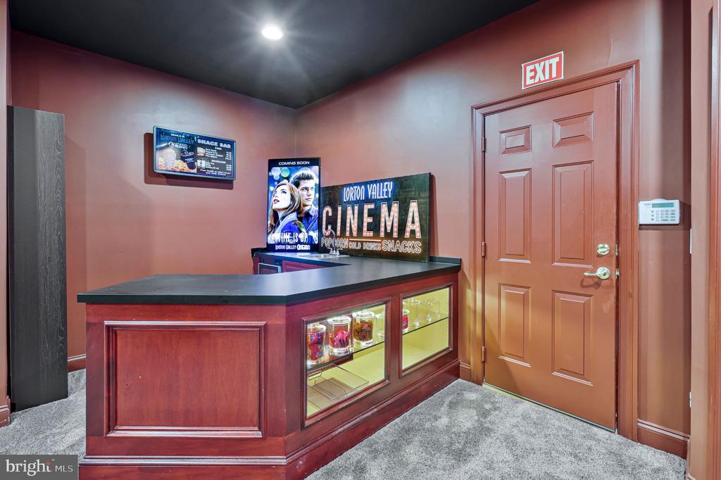 Home theater concession counter with glass snack displays and a Lorton Valley Cinema sign.