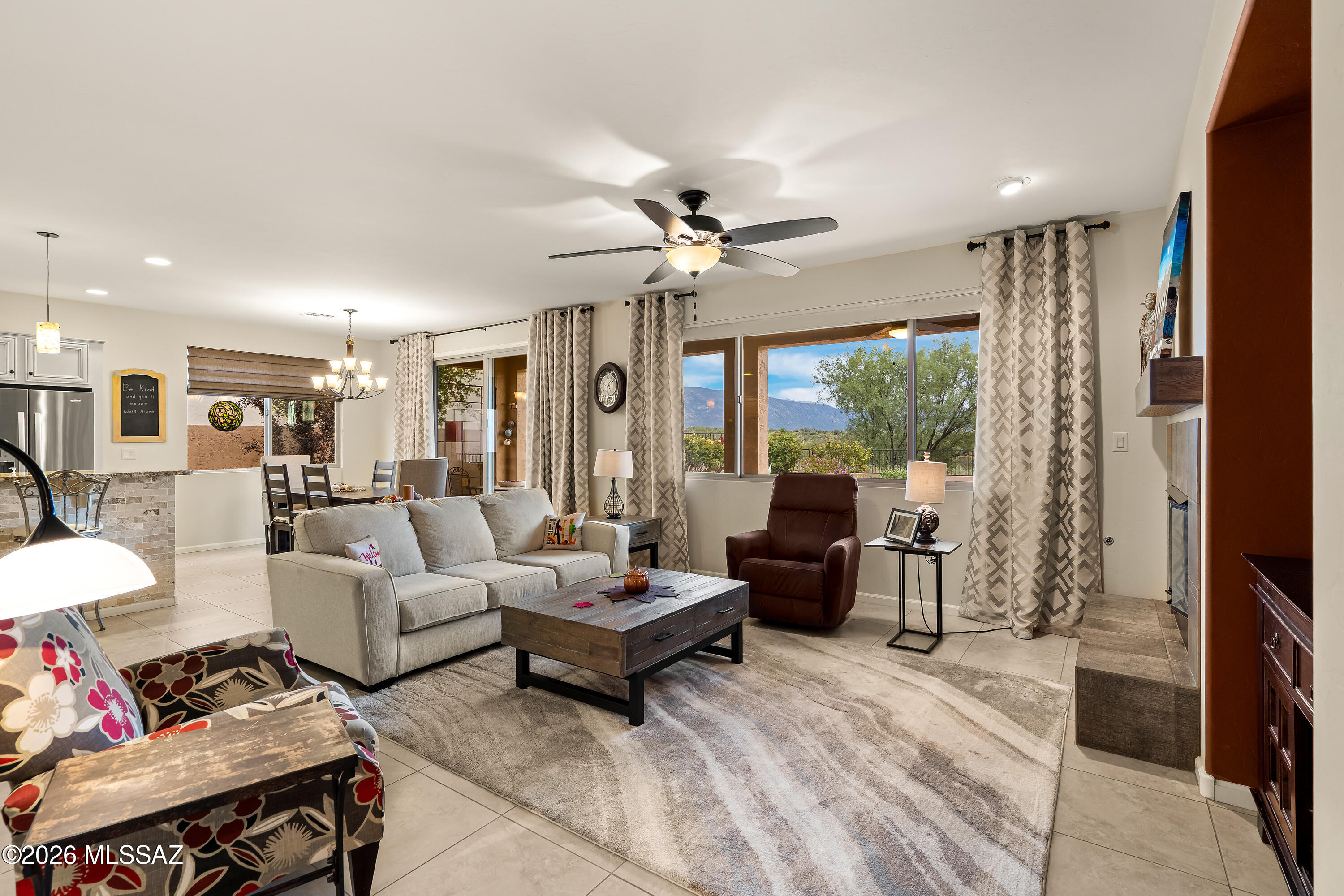 Living room with a large sectional and wide windows overlooking mountains.