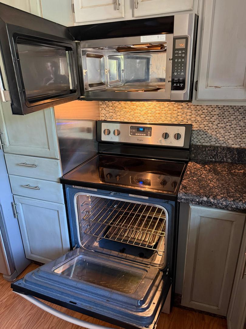 Kitchen with the oven and over-the-range microwave doors open.