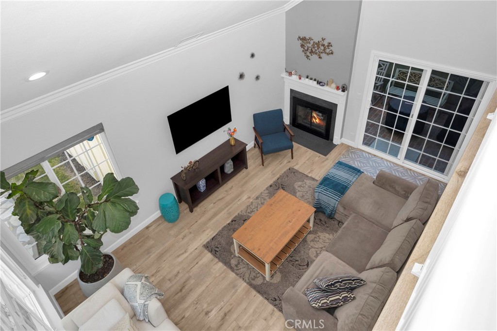 Furnished living room with a fireplace, gray sectional sofa, and sliding glass doors.
