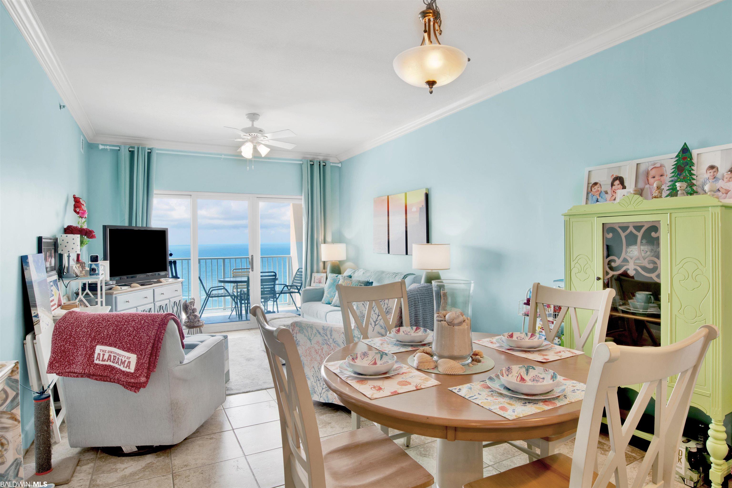 Condo living and dining area with ocean views through sliding glass doors and a lime-green china cabinet.