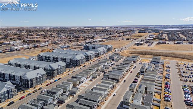 Aerial view of Denver homes and apartment buildings, with streets and parking lots.