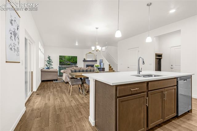 Open-plan kitchen with a large wood-cabinet island and dining and living areas beyond.
