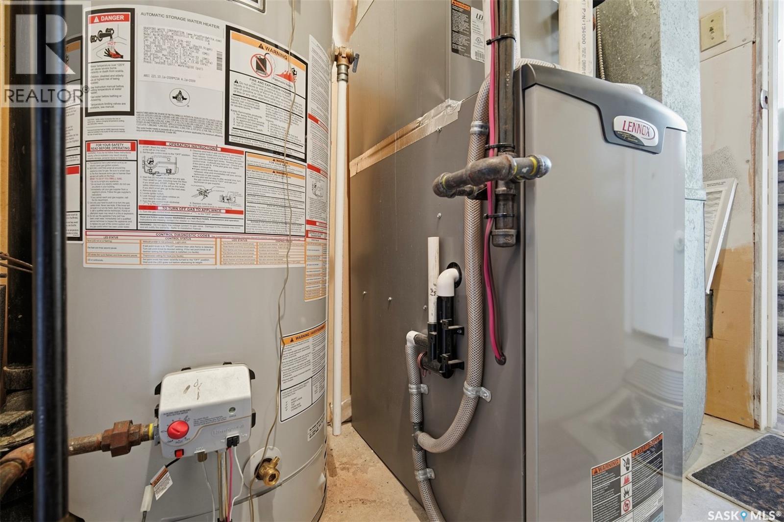 Utility room with a water heater and Lennox furnace.