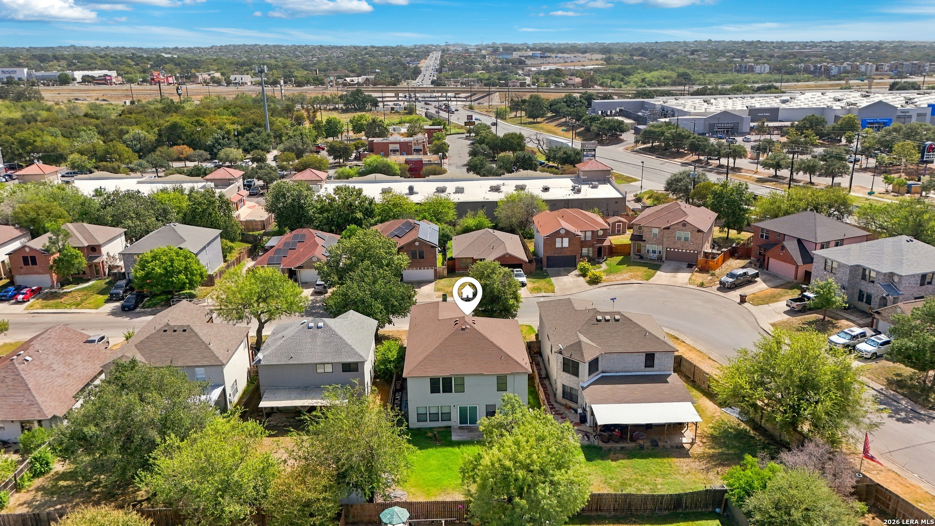 Aerial view of 311 Territory Oak, marked among neighboring homes near a cul-de-sac and commercial buildings.