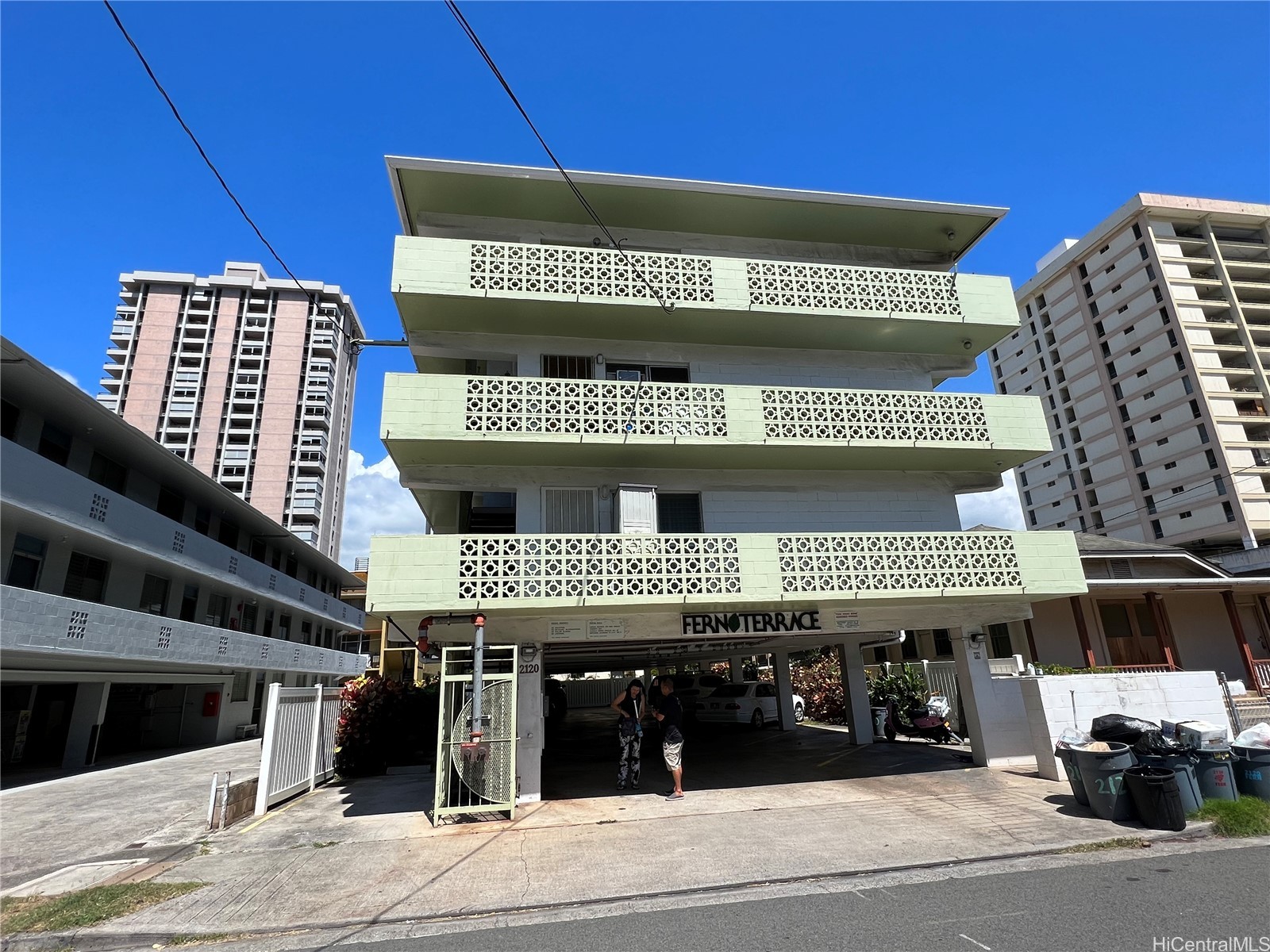 Fern Terrace condominium with pale green balconies and covered parking at the entrance.