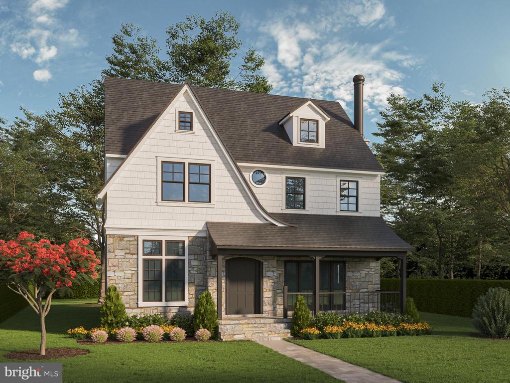 Two-story white and stone house with a covered porch and landscaped front yard.
