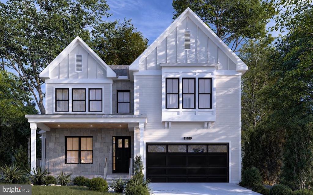 White two-story house with twin gables, a stone-front porch, and a black double garage door.