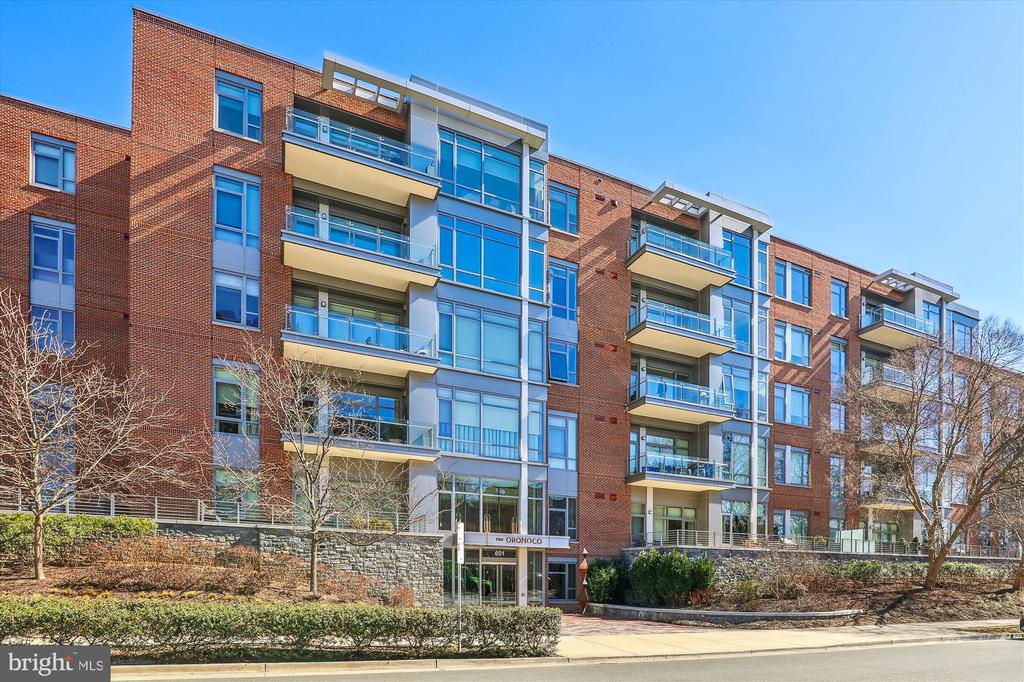 The Oronoco condominium building with red-brick facades, glass balconies, and street-level entrance.
