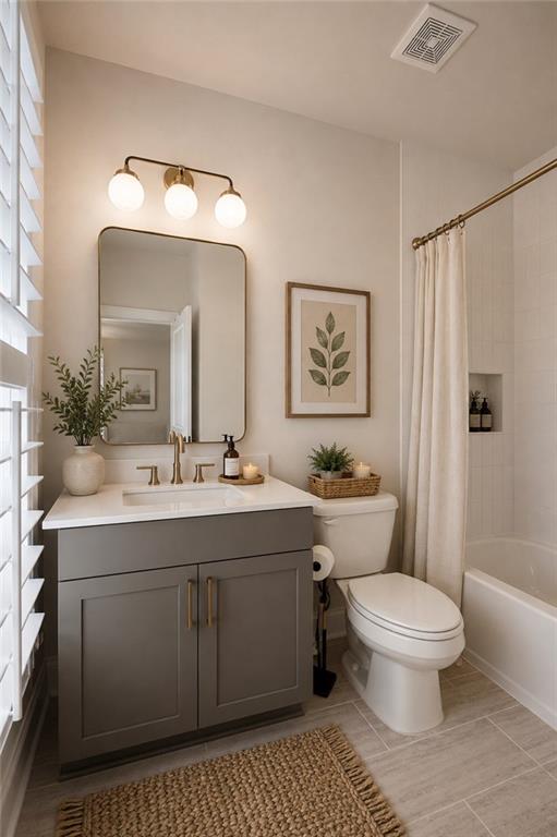 Bathroom with a gray vanity, globe lights, toilet, and curtained bathtub.