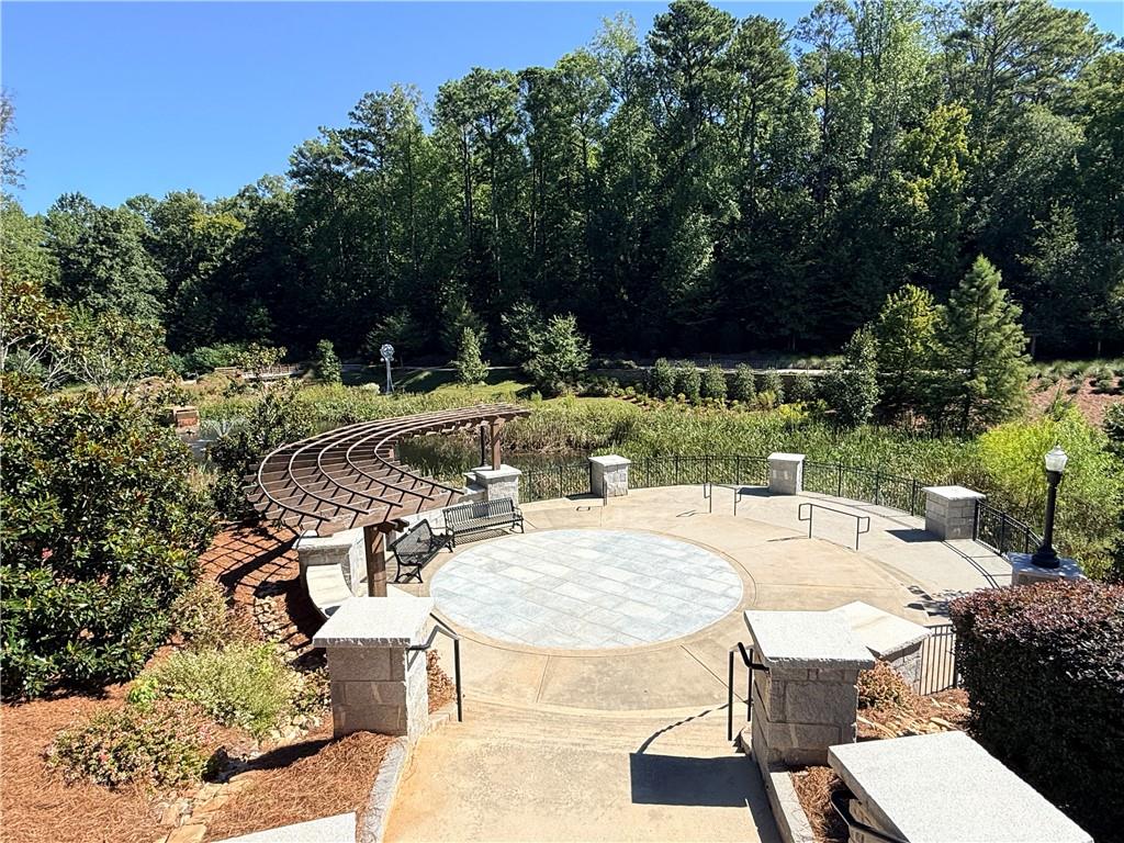 Landscaped outdoor plaza with a circular paved area and curved tiered seating.