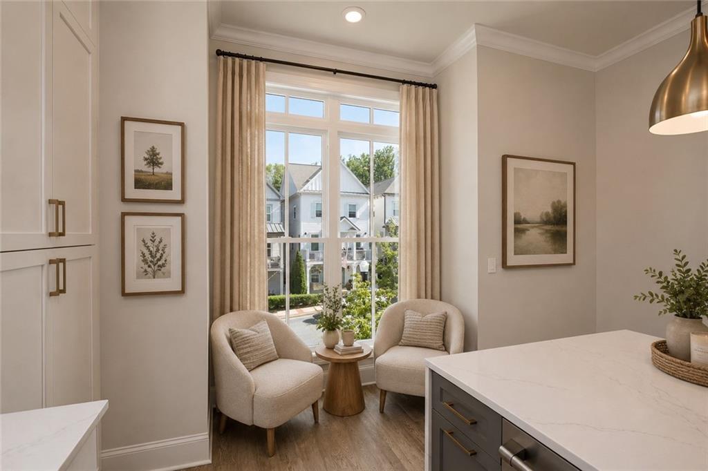 Bright kitchen with a window-side seating nook and white island.